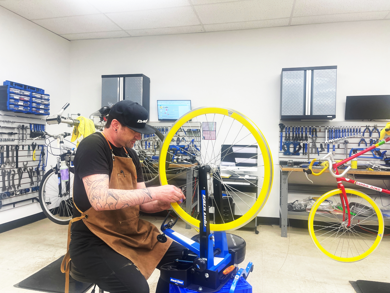 Student at Central Alberta Bicycle School (CABS) truing a wheel.